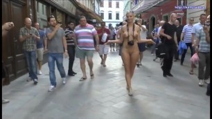 Sexy blonde walks naked through the streets of the old city